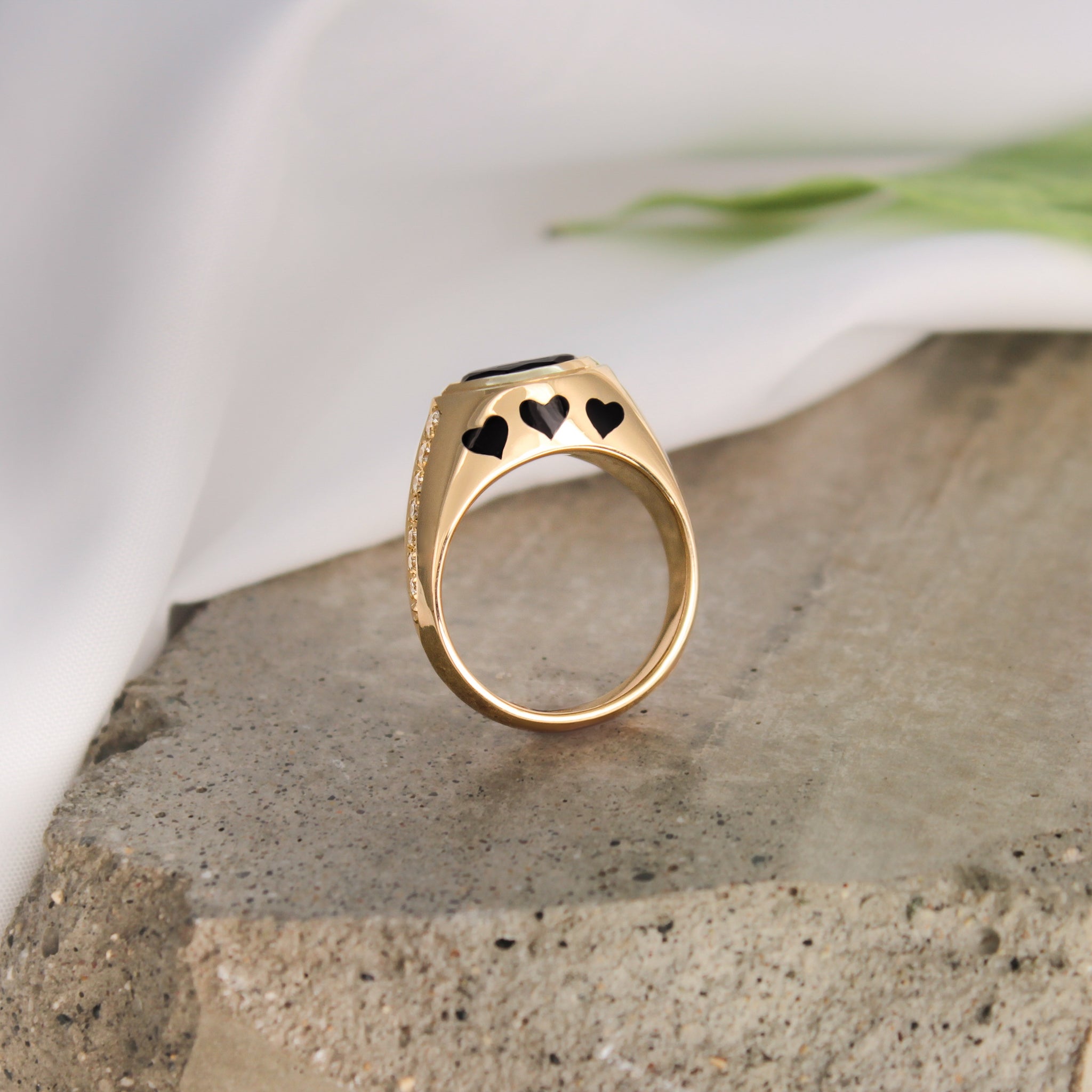 14k Yellow Gold ring with black enamel hearts and accent diamonds."