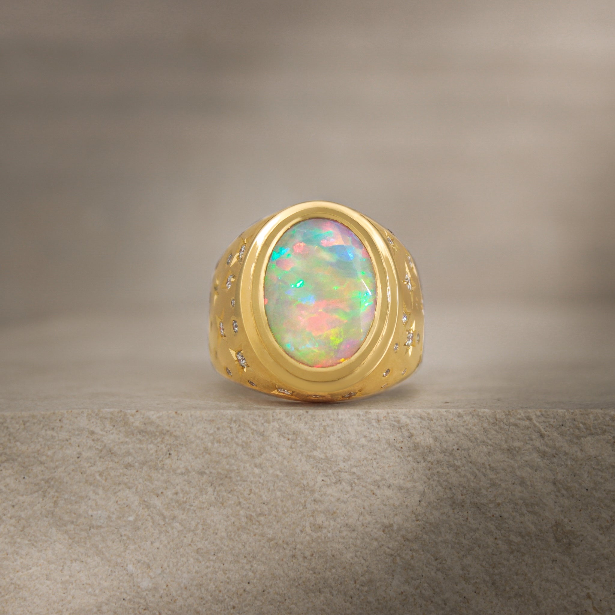 front view of Galaxy III signet ring showcasing the stunning 4ct opal stone with a rainbow of bright colors.