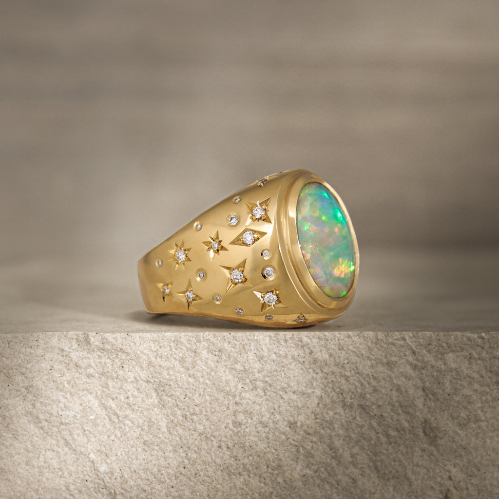 Side view of Galaxy III signet ring with a galaxy-inspired design featuring diamonds of varying sizes and shapes around the band.