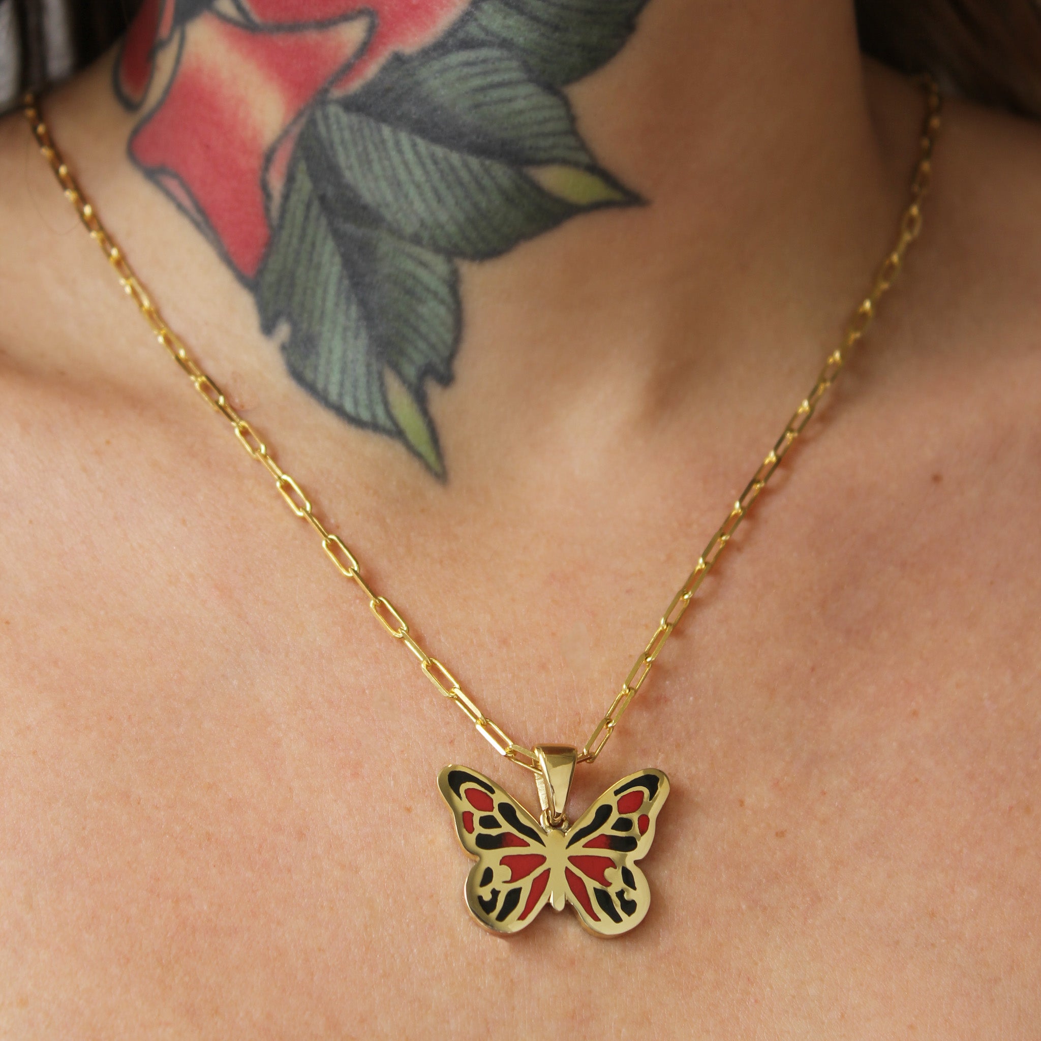 Model wearing the butterfly pendant on a delicate gold chain, creating a striking and unique look.